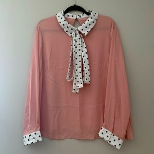 Dusty rose sheer long sleeve blouse. B&W polka dot sleeve and collar tie neck.